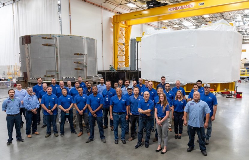 The General Atomics fabrication team poses in front of the first two modules of the central solenoid. Module 1, at right, is packaged for shipment. Module 2, at left, will be shipped later this summer. Courtesy General Atomics. (Click to view larger version...)